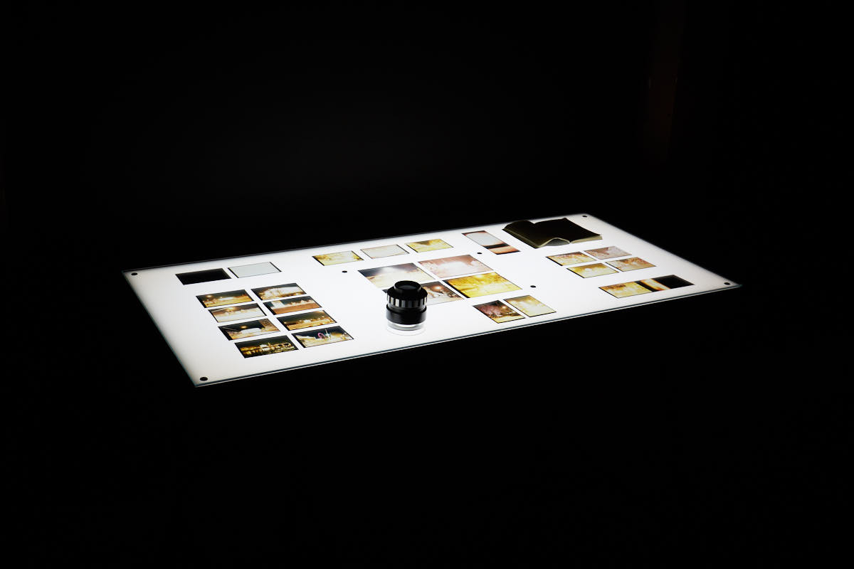 The Darkroom light table is an interactive installation piece where the spectator can read and explore 24 original transparencies with a 4x magnification.